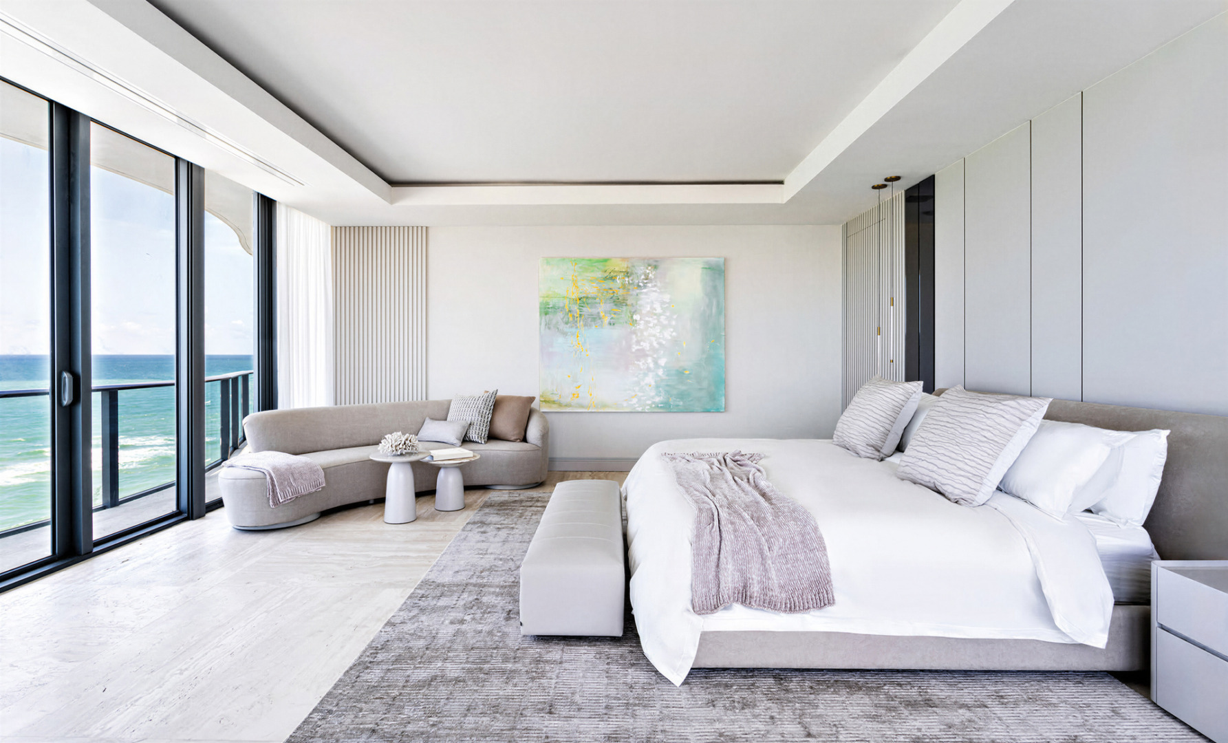 Modern luxury meets ocean views in a sophisticated, airy setting, defined by neutral tones, clean lines, and contemporary design. Regalia Residences is a project by FL Interiors, featuring Harmony Luxury Furniture.