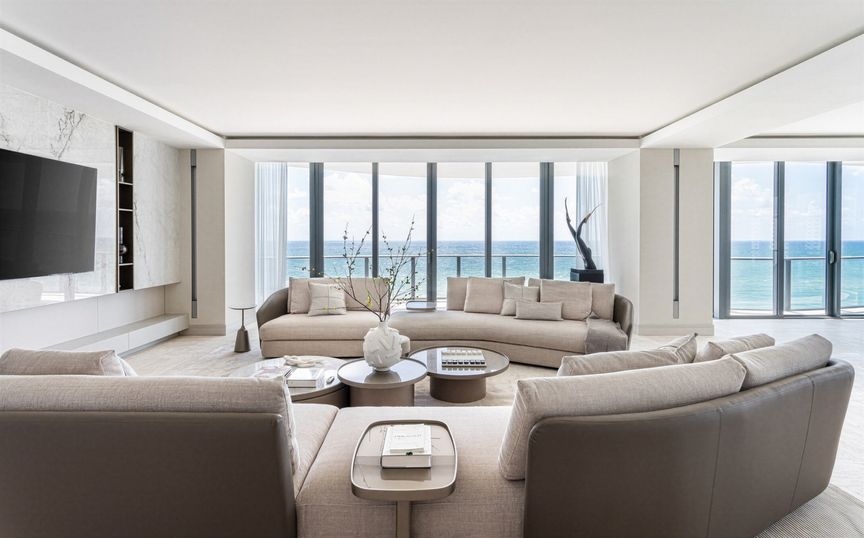 Modern luxury meets ocean views in a sophisticated, airy setting, defined by neutral tones, clean lines, and contemporary design. Regalia Residences is a project by FL Interiors, featuring Harmony Luxury Furniture.